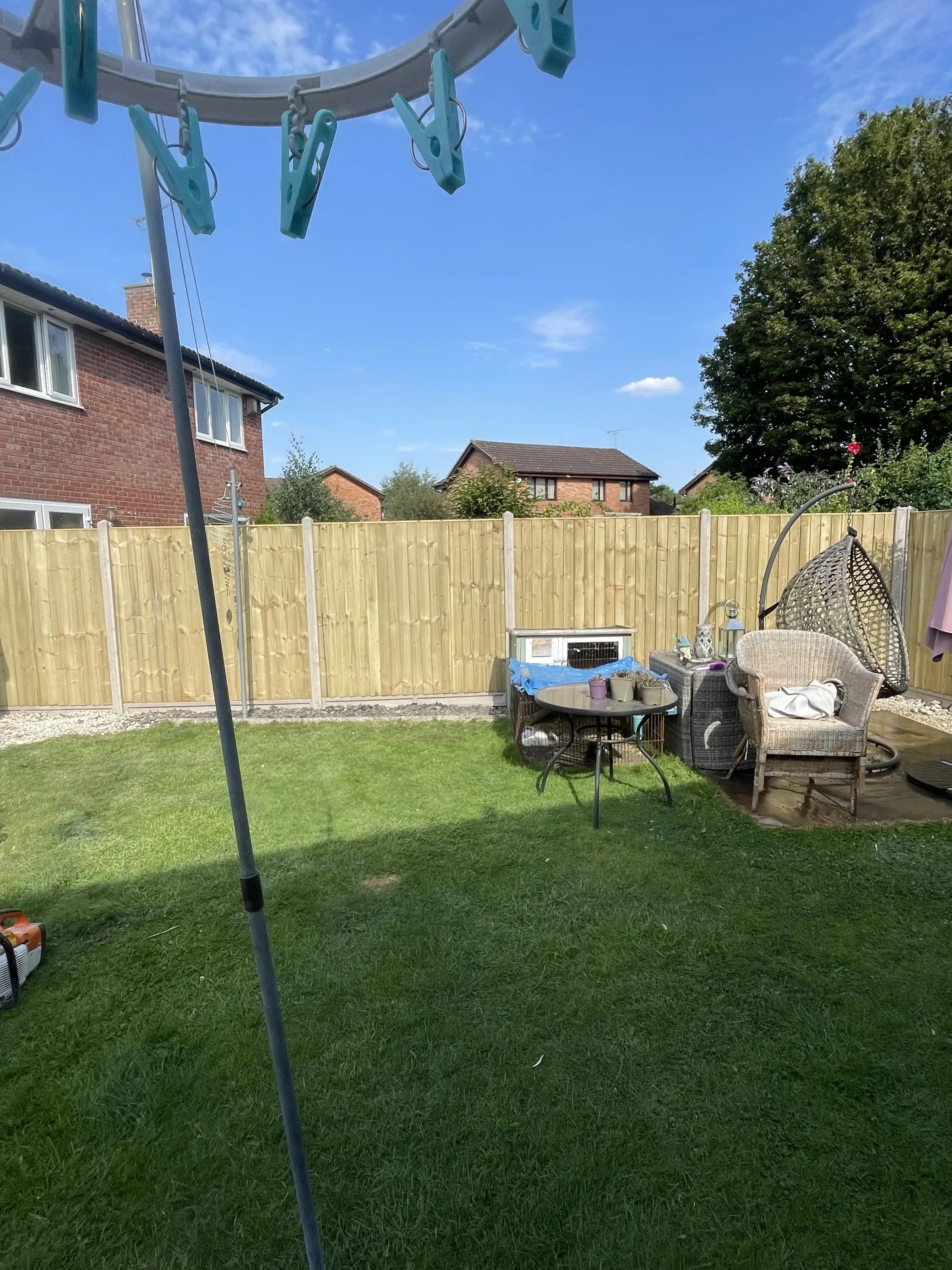 Closeboard fence enclosing a family garden lawn