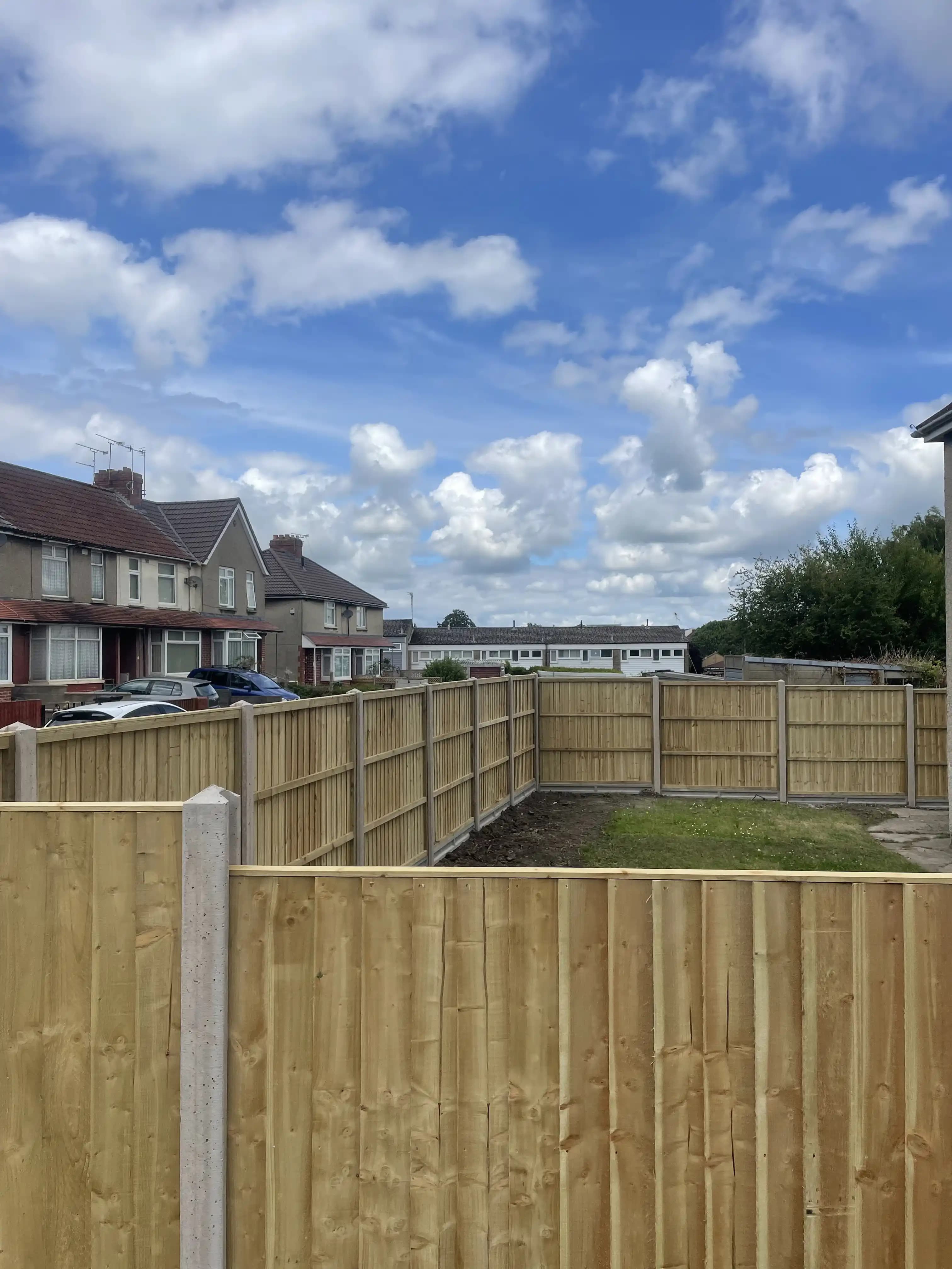 Closeboard fence around a new build garden in bright weather