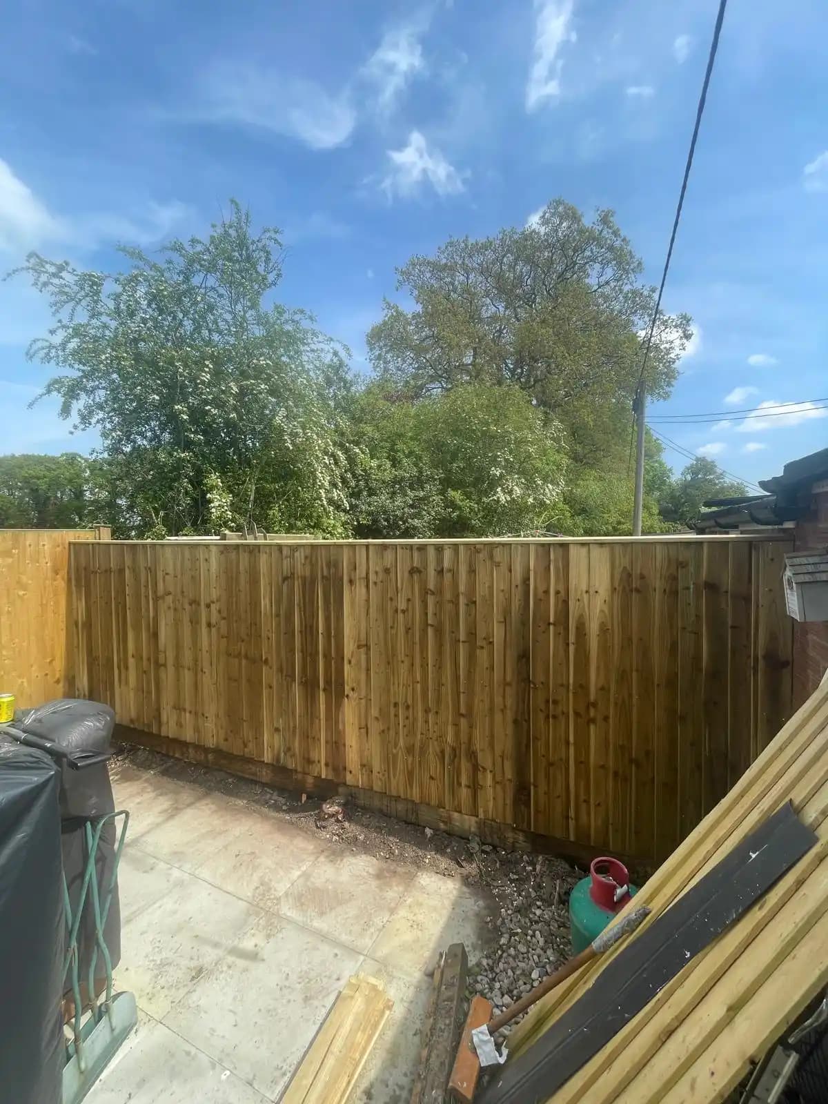 Closeboard fence around a sunny patio garden