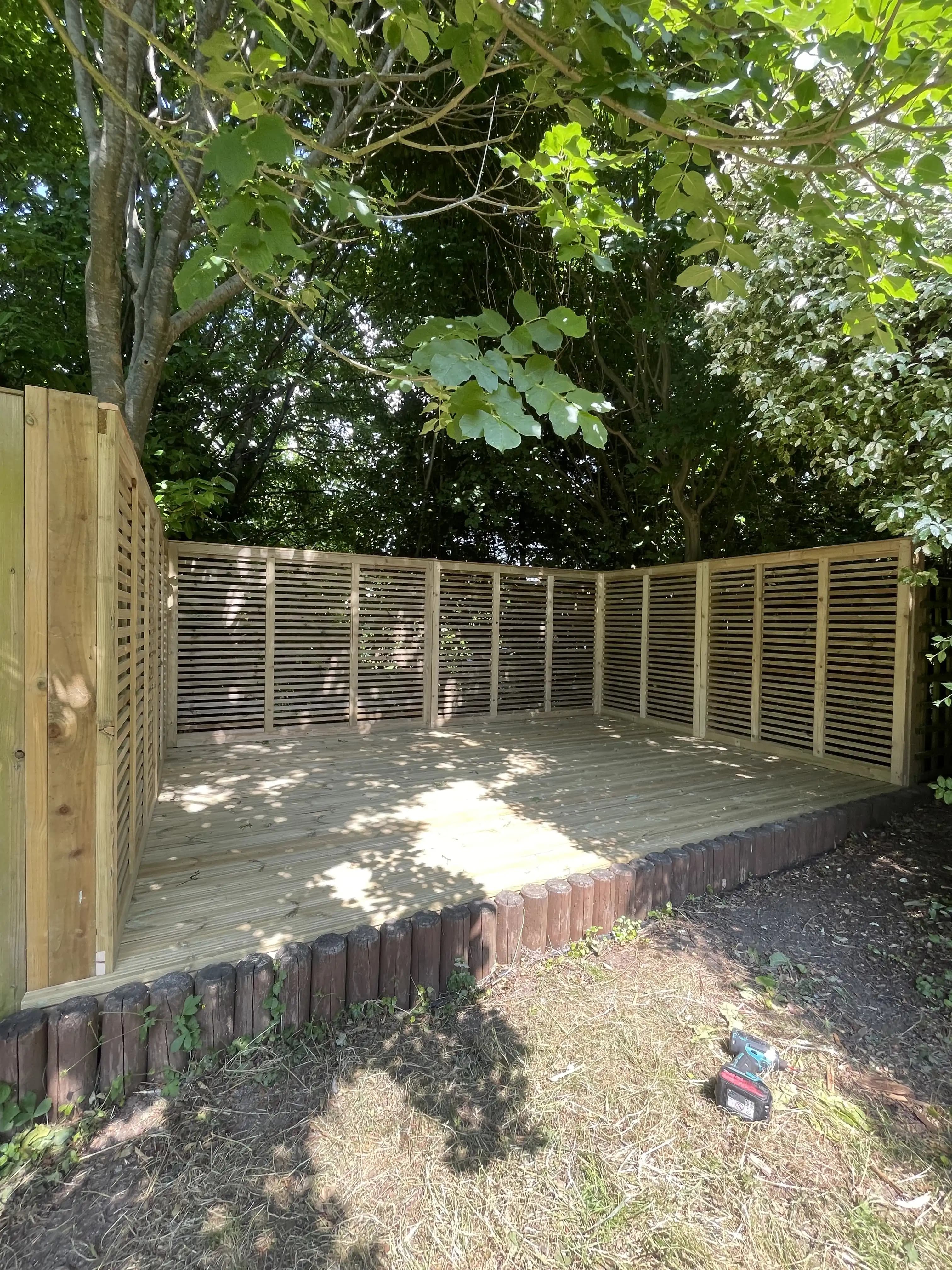 Timber balustrade fence around a raised decking area