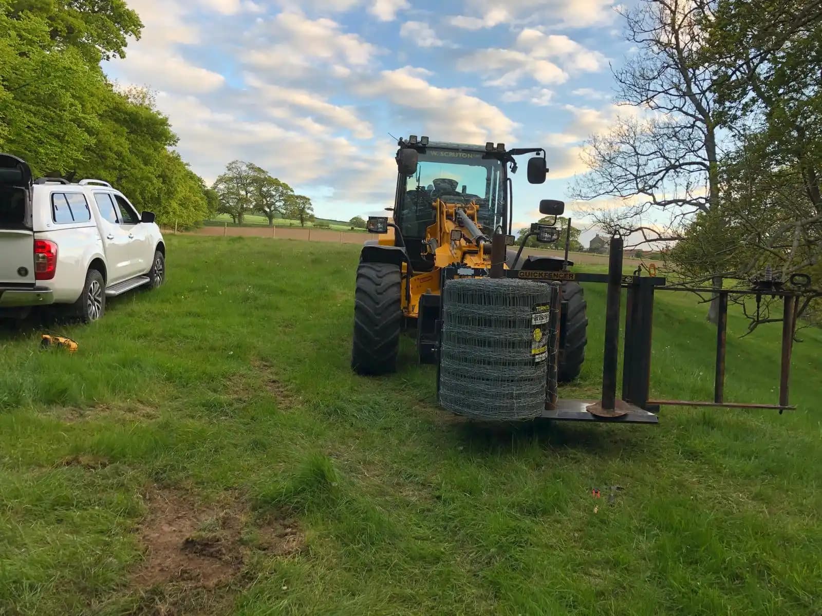 Field fence installation with a mini loader and work vehicle