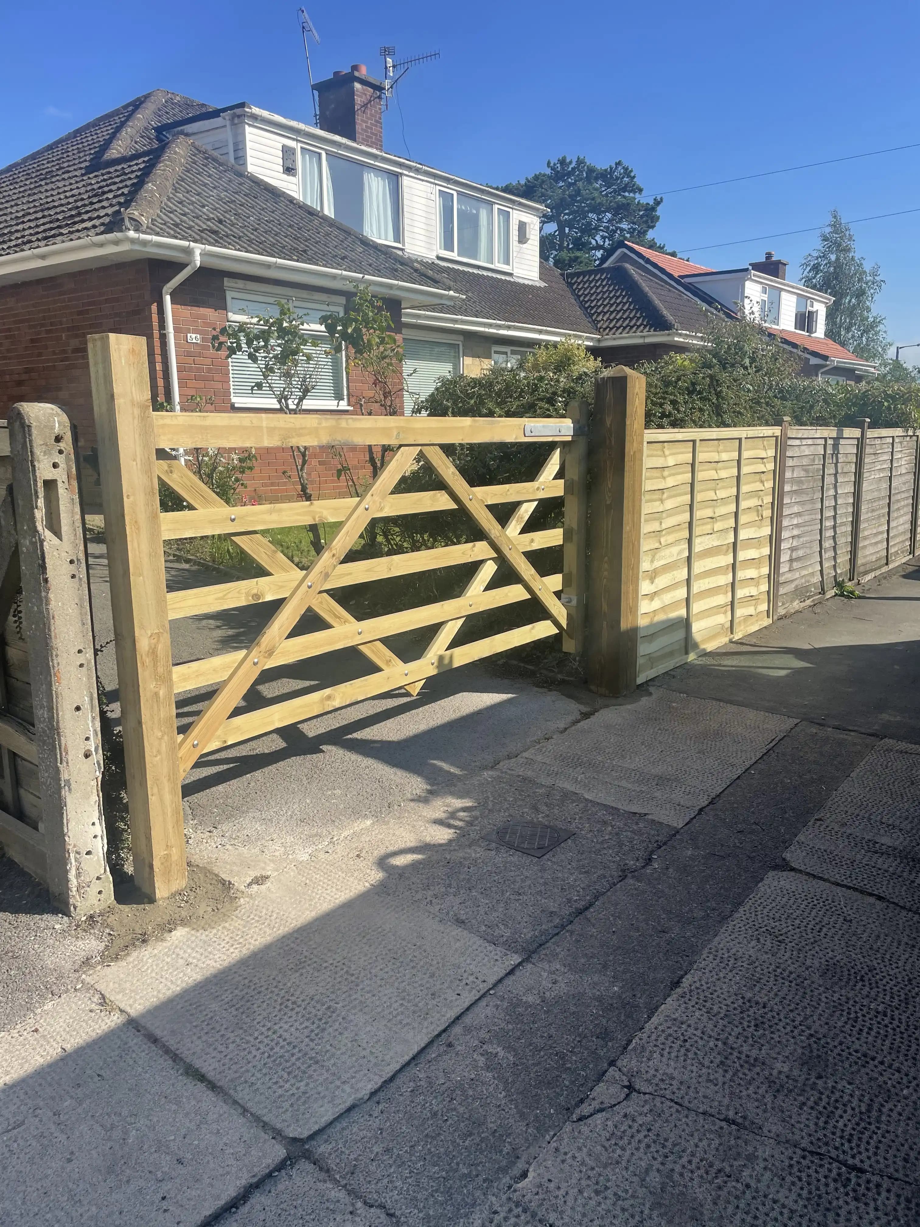 Timber five bar driveway gate with matching fence panels