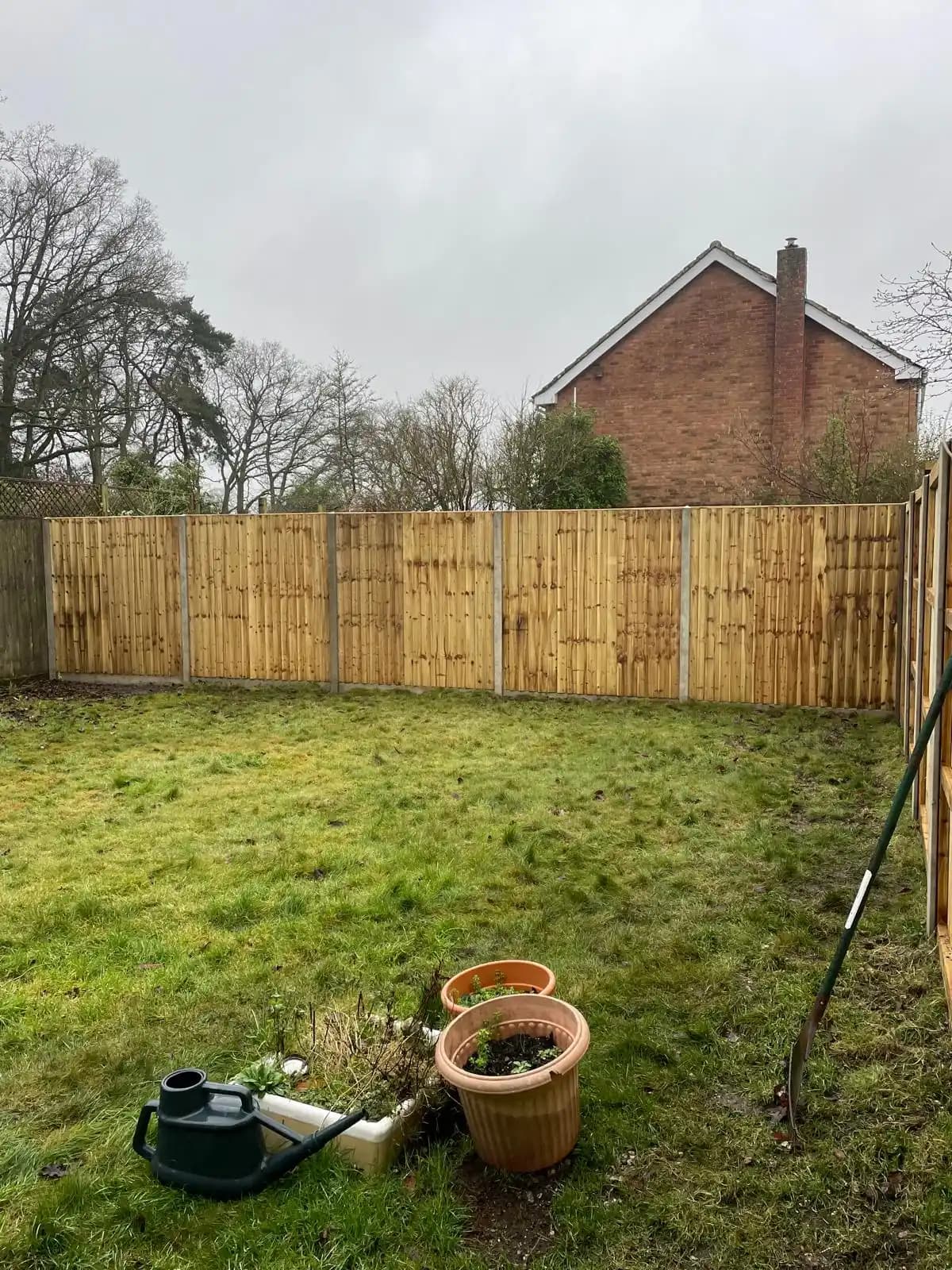 Closeboard fence along a front garden lawn