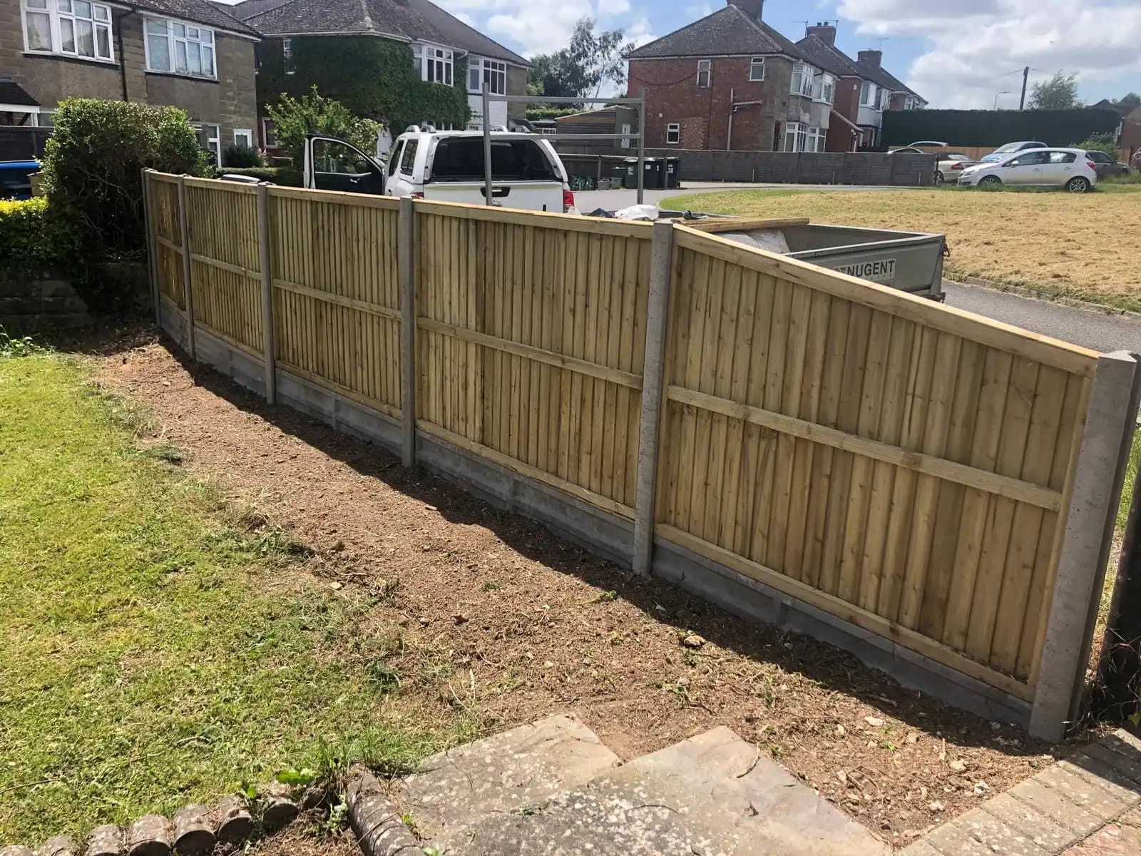 Closeboard fence on gravel boards along a front garden boundary