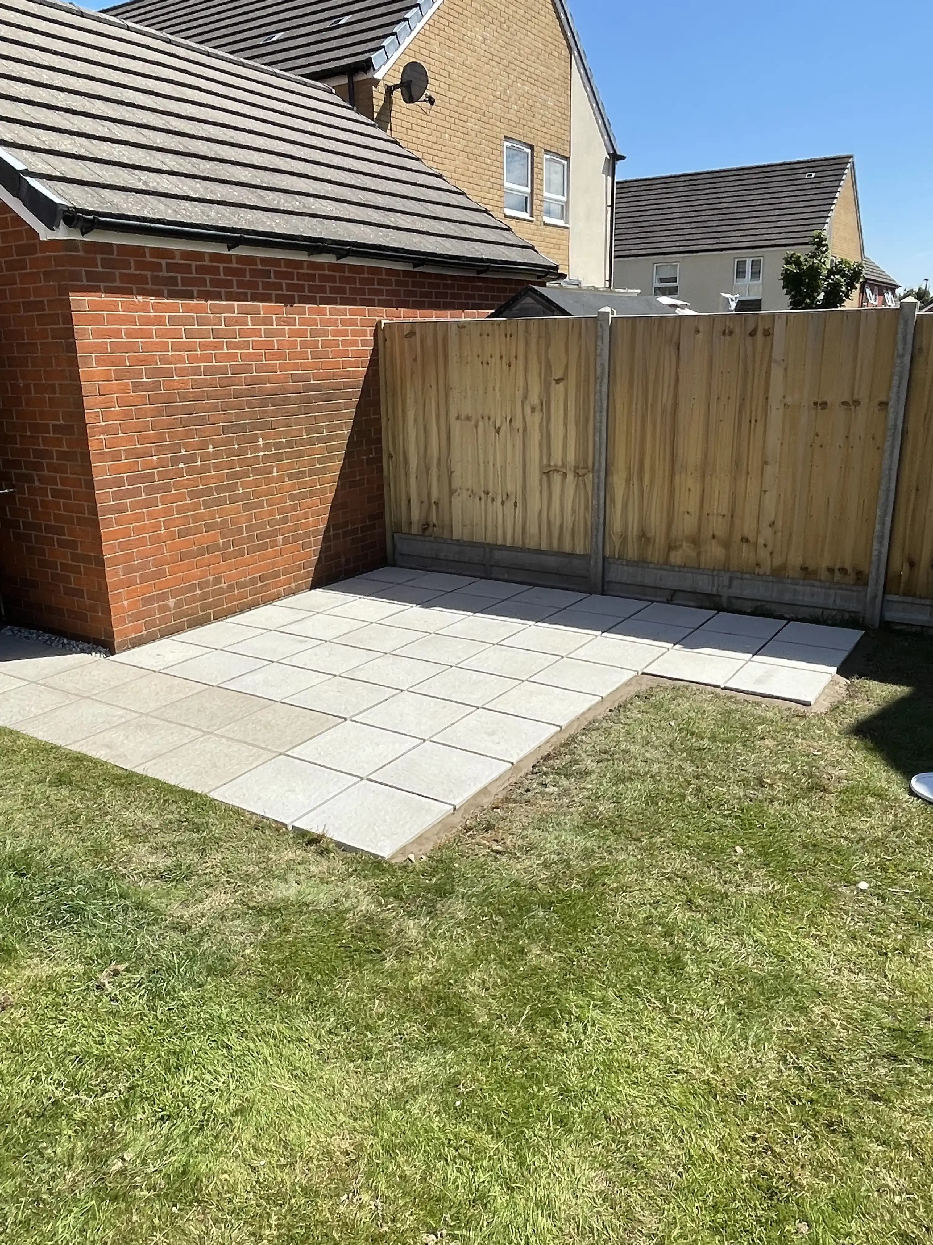 Closeboard fence around a patio corner and lawn