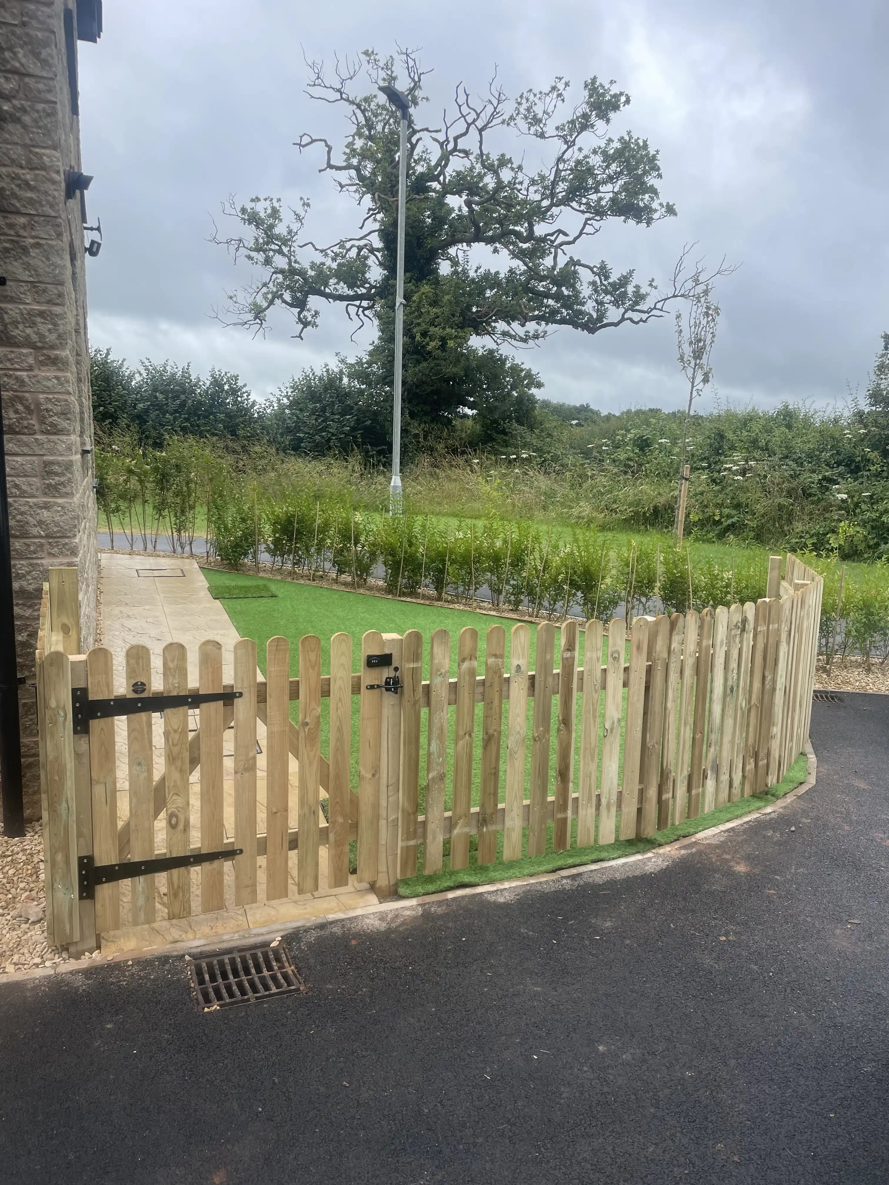 Picket fence and gate at a rural driveway entrance