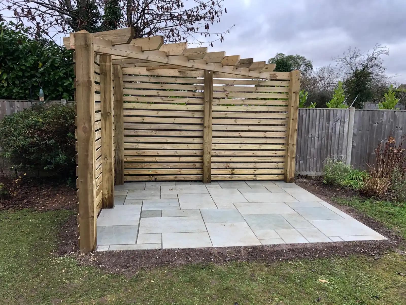 Decorative screening fence around a paved patio corner