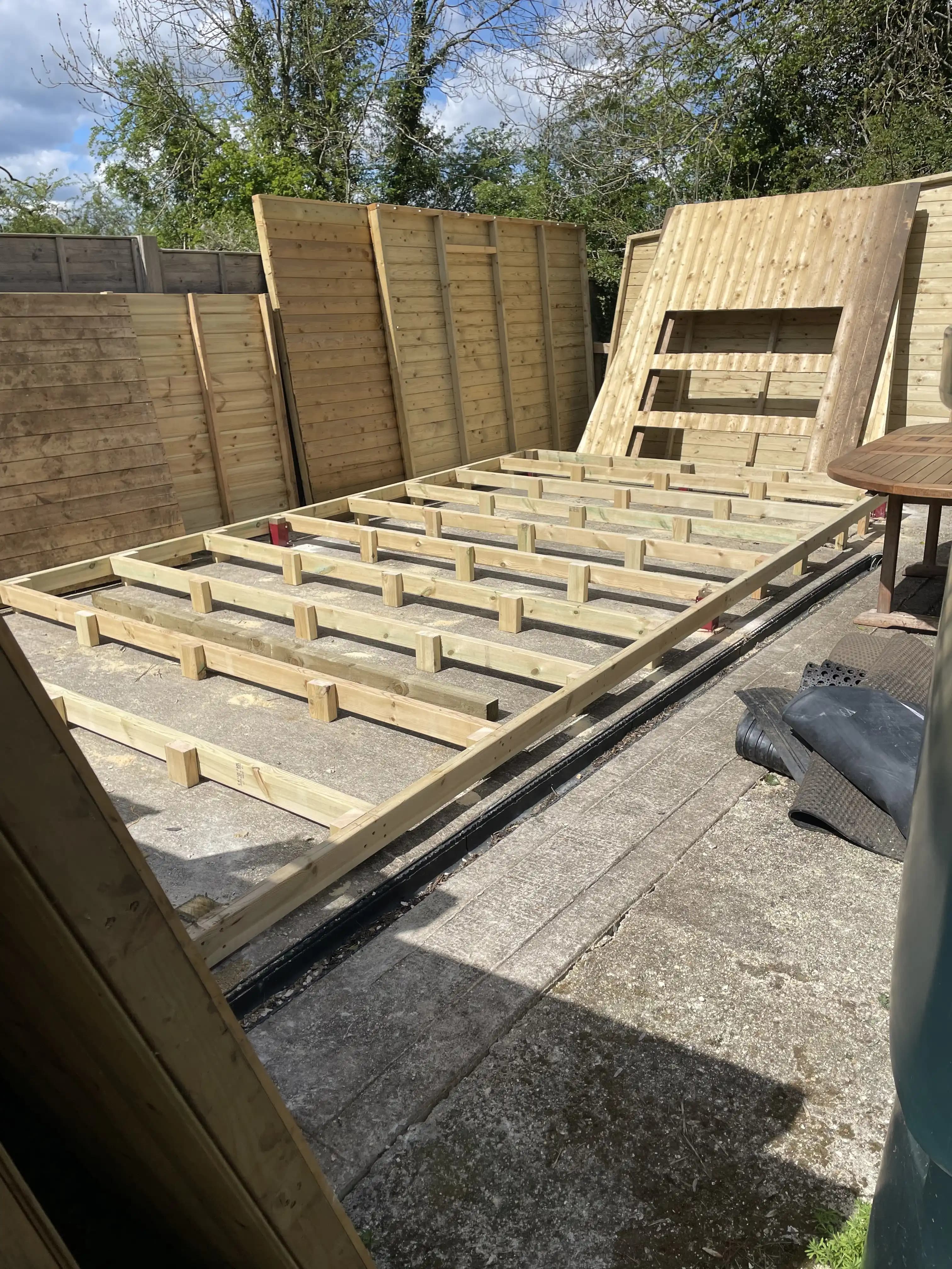 Timber garden building frame laid out during construction