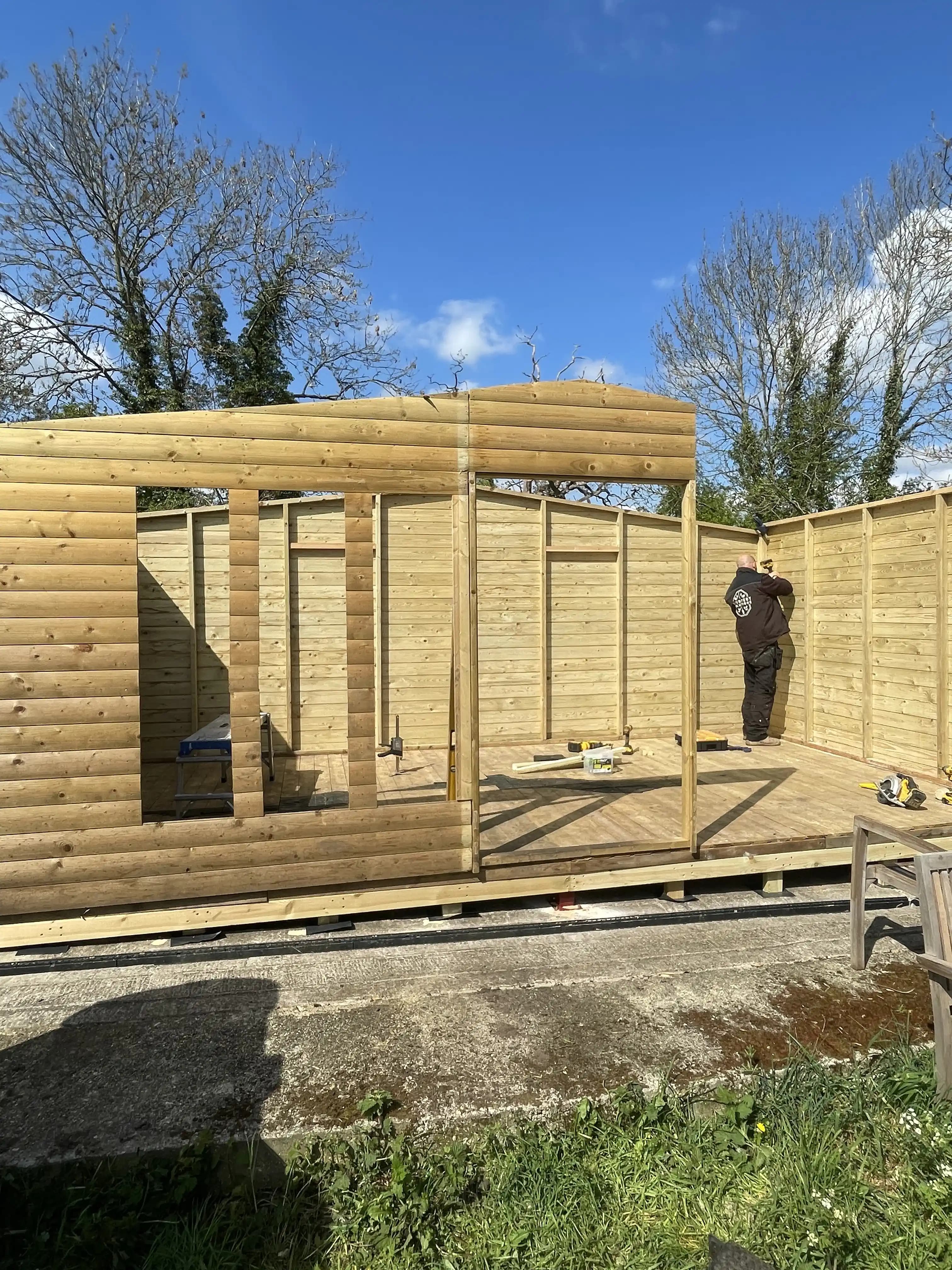 Timber garden room frame under construction in sunny weather