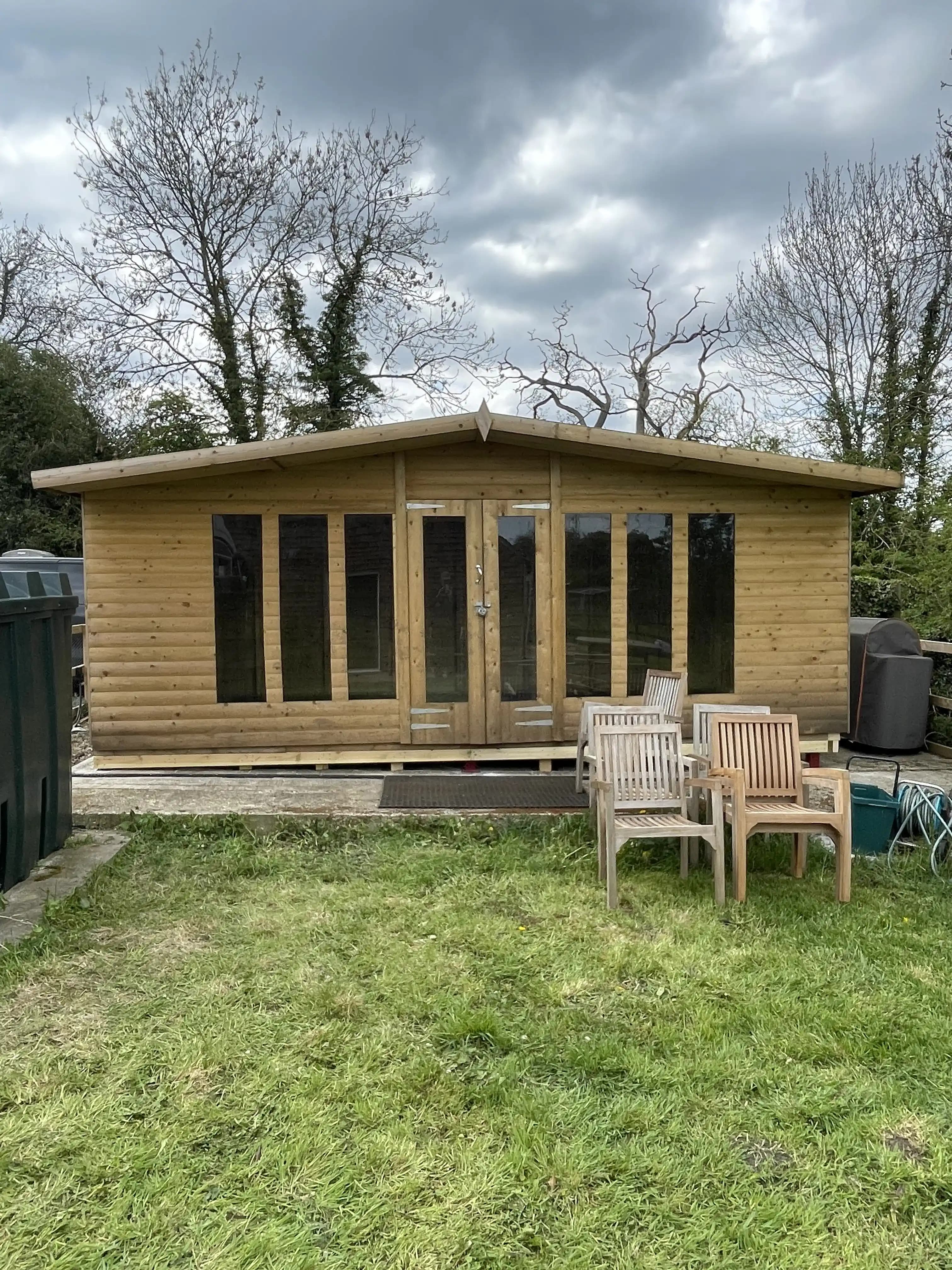 Front view of a completed timber garden room in a back garden