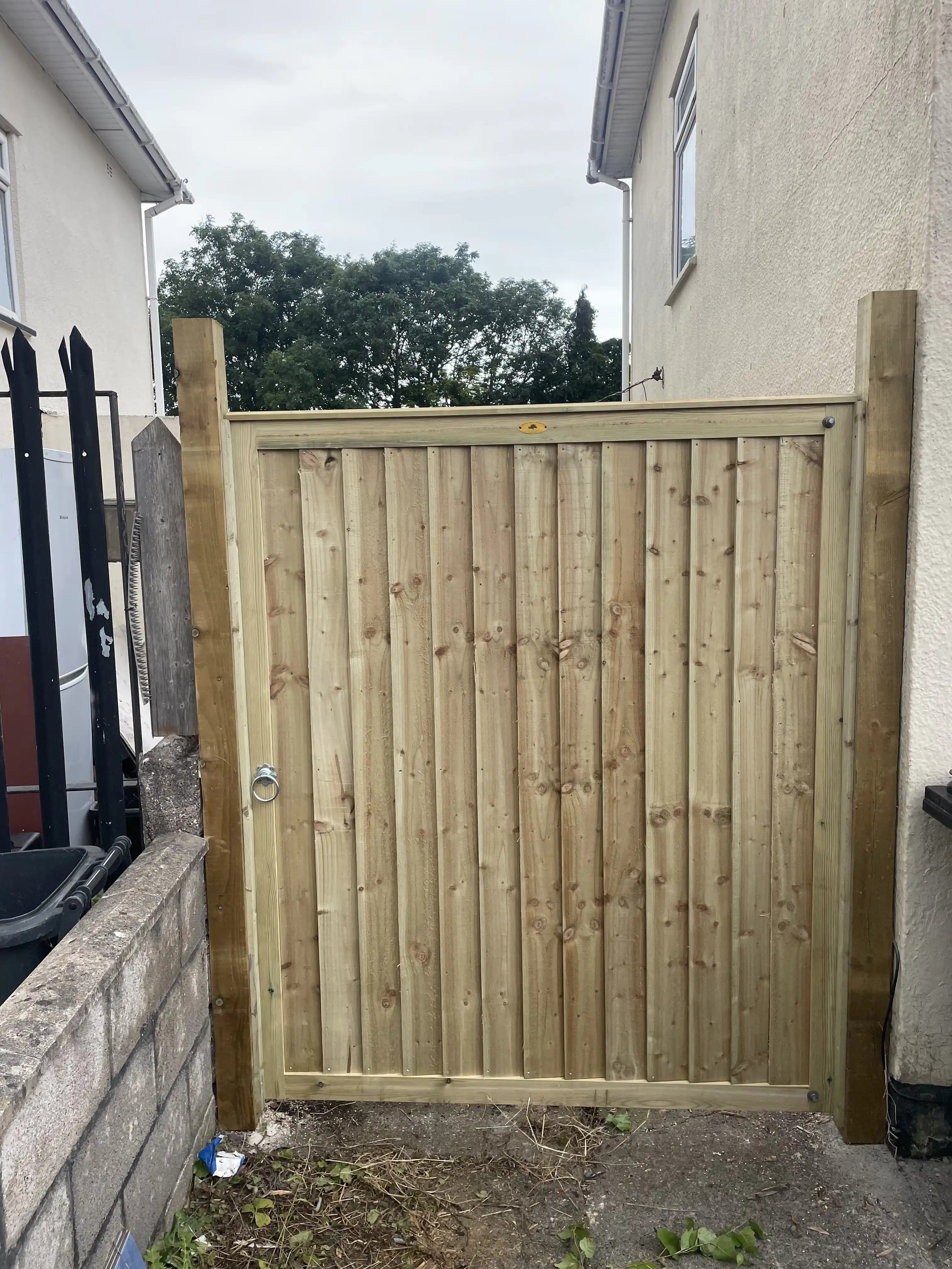 Timber side gate fitted between two houses
