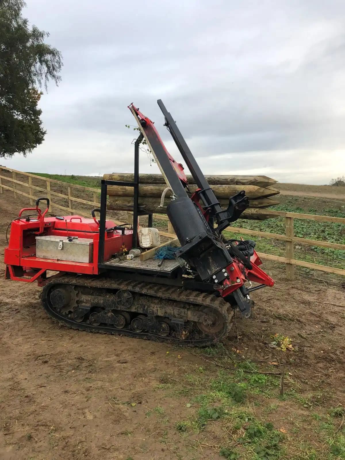 Tracked post driver used for rural fence installation