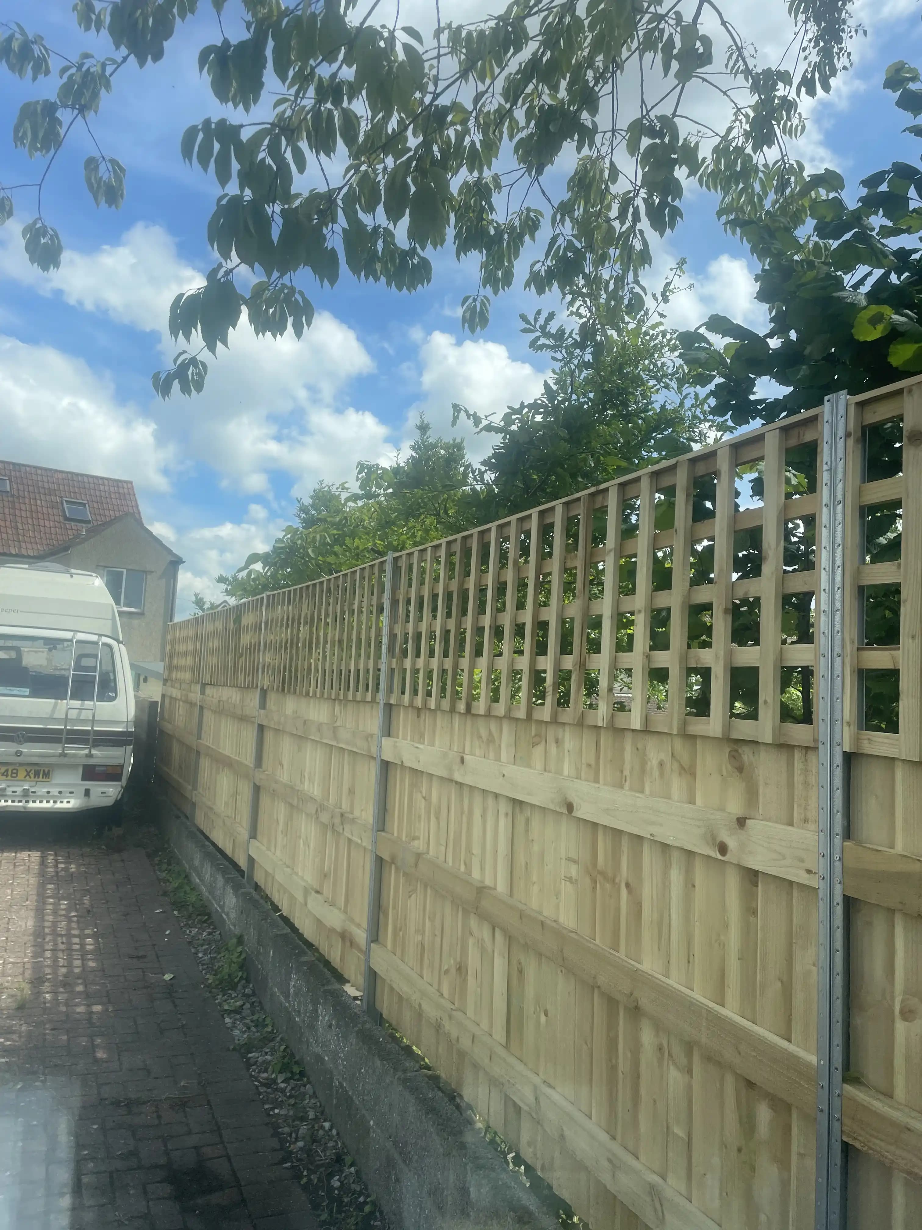 Trellis top fence along a driveway boundary