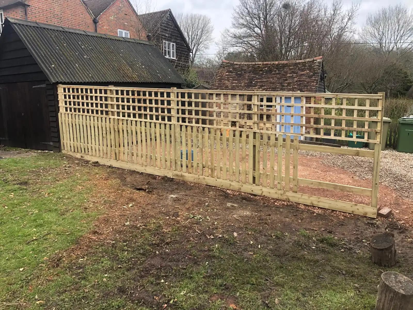 Trellis top fence along a garden lawn border