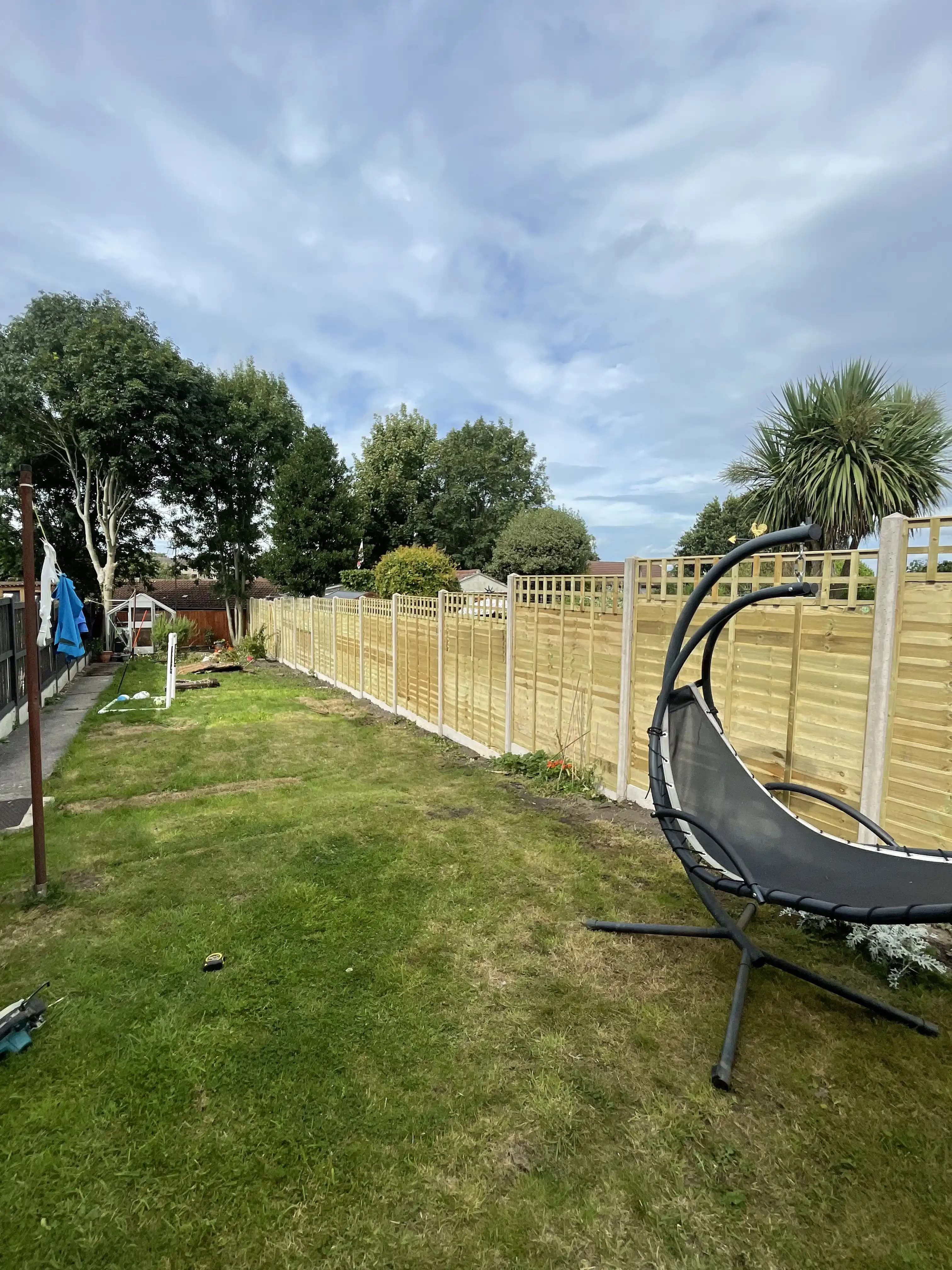 Long trellis top fence running down a garden lawn
