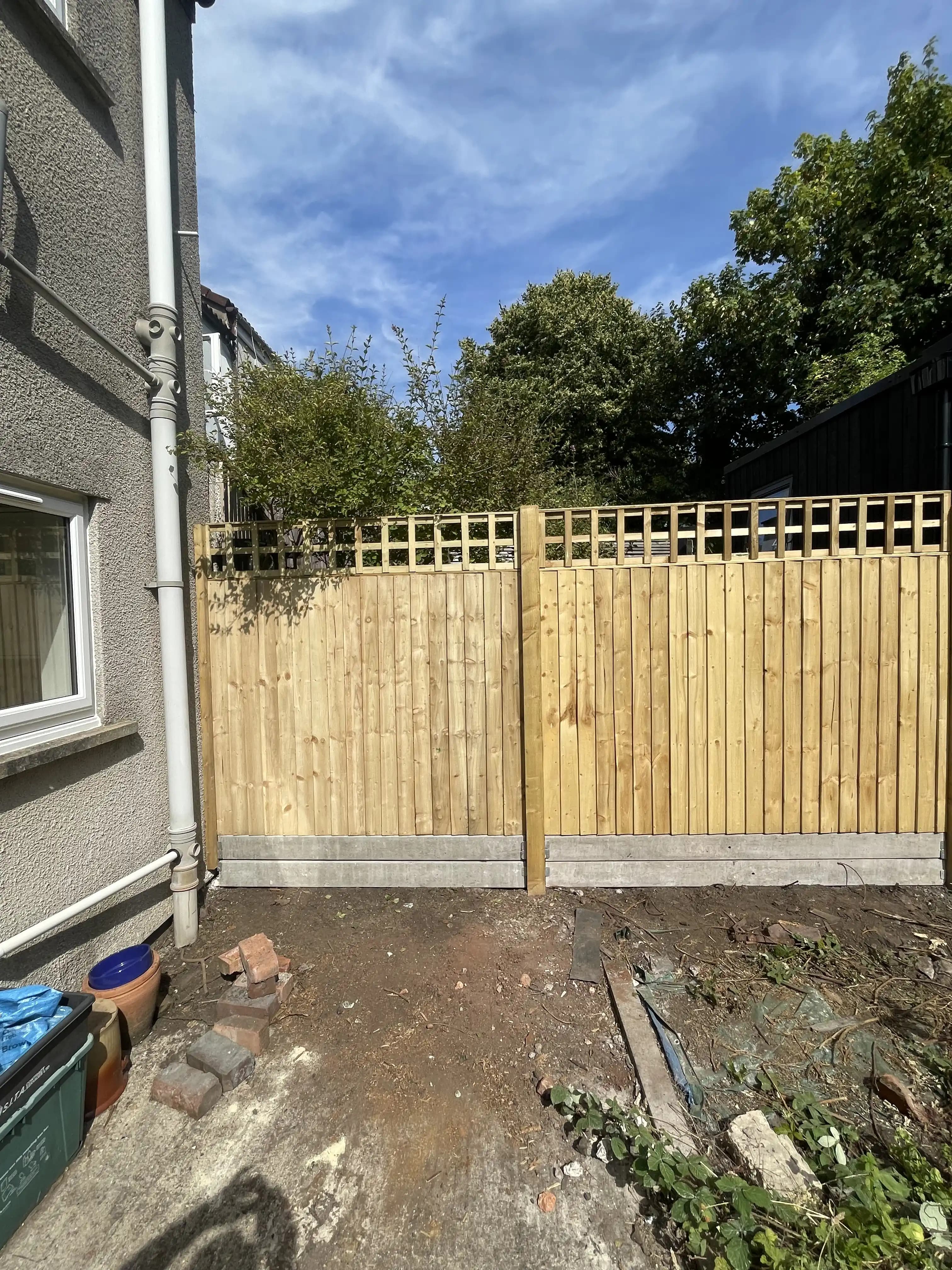 Trellis top fence closing off a side garden area